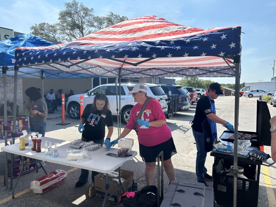 On a warm August day, volunteers prepare hot dogs as about 20 veterans wait for a bite outside an adjacent building.